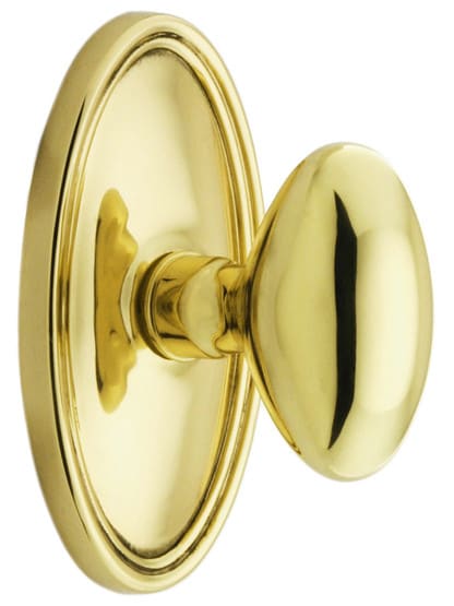 Oval Rosette Set With Elliptical Brass Knobs in Polished Brass.